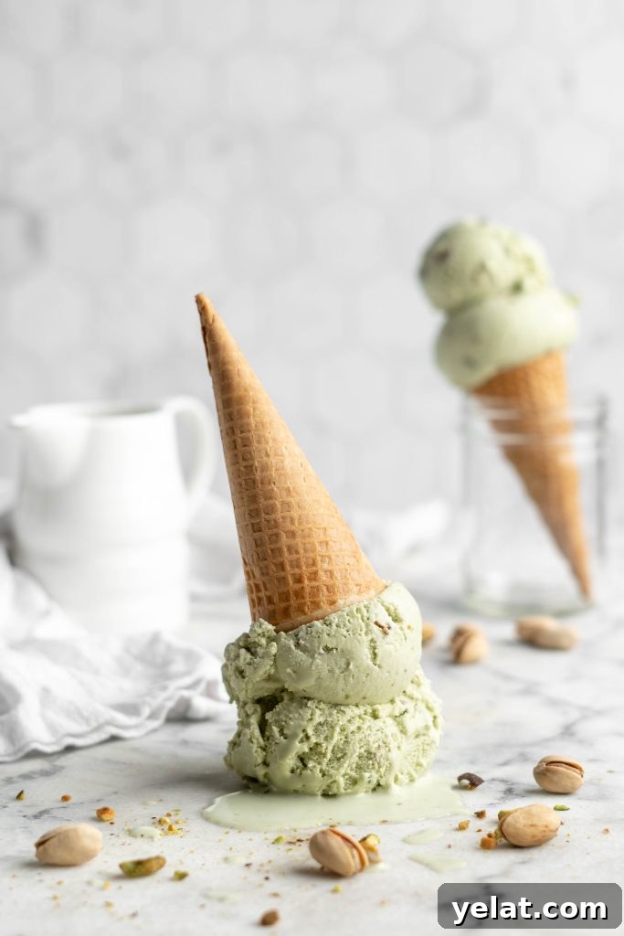 Homemade Pistachio Ice Cream Recipe with Creamy Texture 10 pistachio ice cream scoops in a cone upside down
