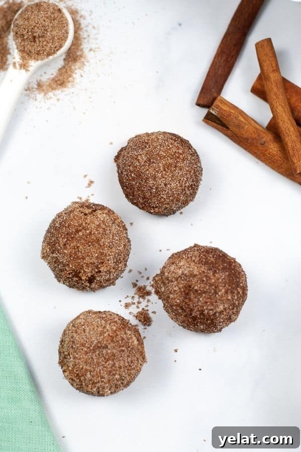 Shot from the top of 4 churro bites on a white dish