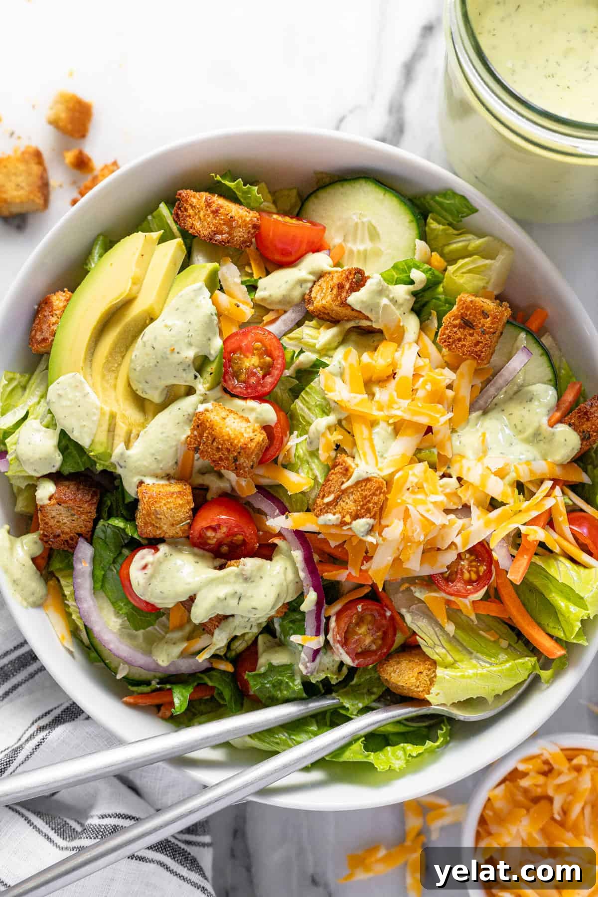 5-Minute Avocado Lime Ranch Dressing (Chick-fil-A Copycat) 7 Large bowl filled with a house salad topped with creamy avocado lime ranch dressing.
