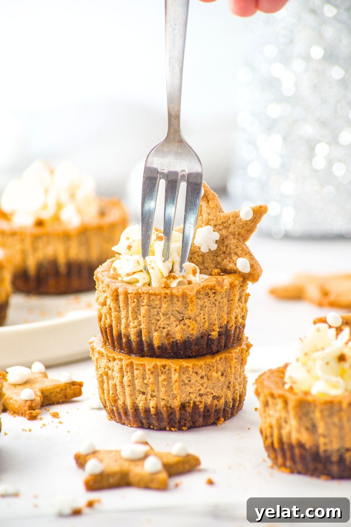 Mini Gingerbread Cheesecakes (Gluten-Free, Dairy-Free Option) Fork poking into a stack of mini gingerbread cheesecakes