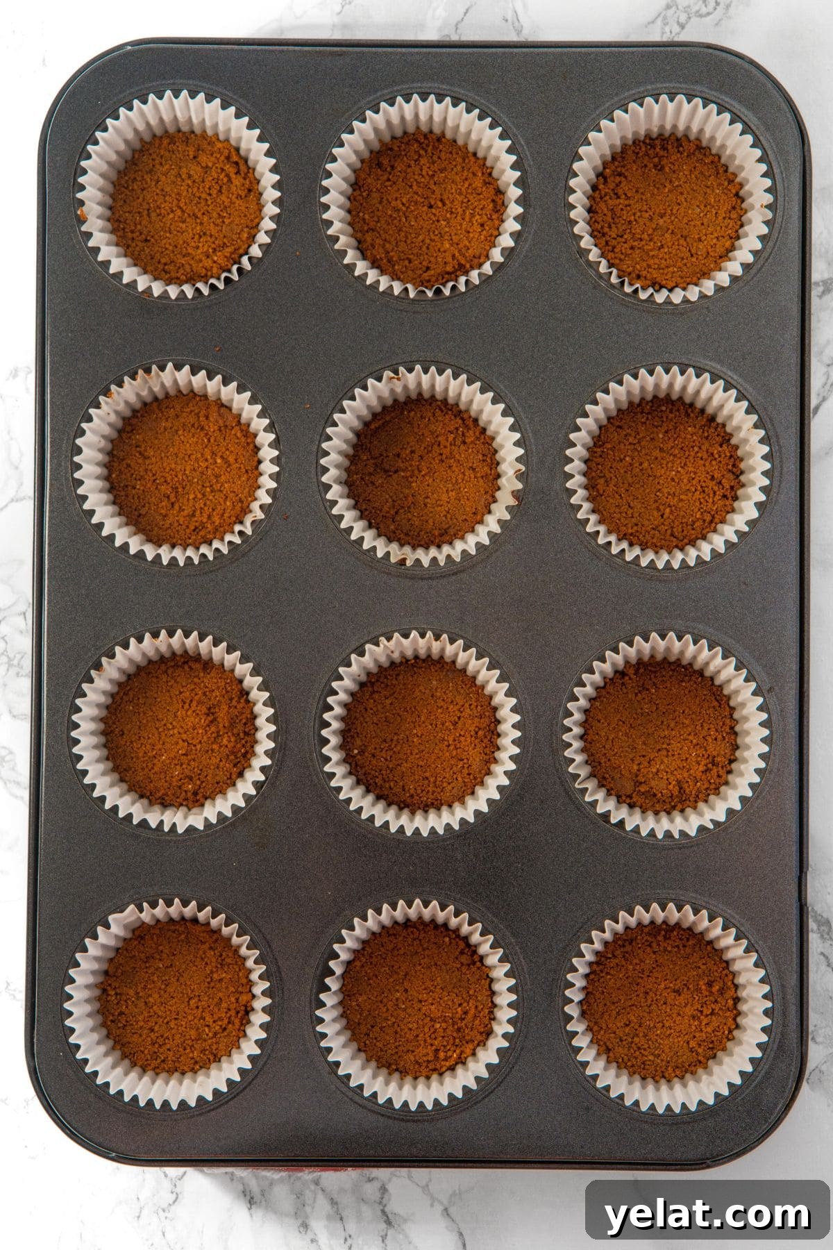 Individual Gingerbread Cheesecakes (Gluten-Free, Dairy-Free Option) Graham cracker crumb base in muffin pan
