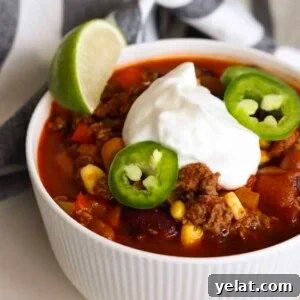 Hearty White Bean and Chicken Soup with Garlic and Herbs 12 Bowl of high protein chili topped with greek yogurt and jalapeno slices