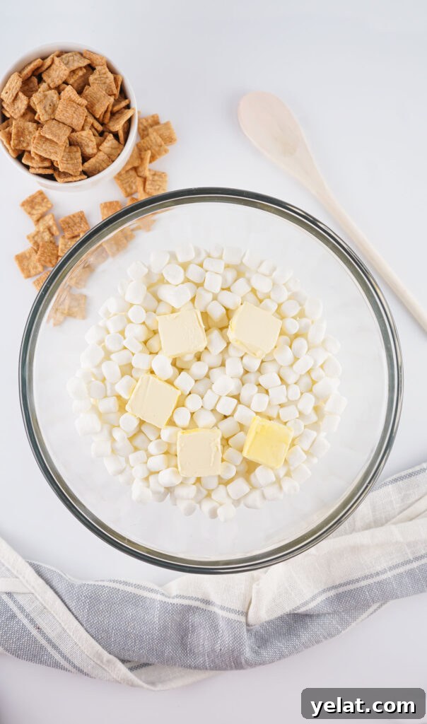 Cinnamon Toast Crunch Marshmallow Bars: Gooey Cereal Treats 4 marshmallows and butter pats in glass bowl for cinnamon toast crunch treats
