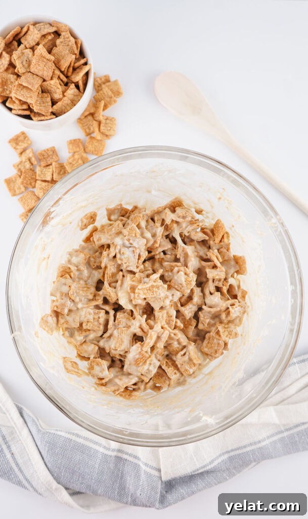 Cinnamon Toast Crunch Marshmallow Bars: Gooey Cereal Treats 6 mixing cinnamon toast crunch treats in glass bowl