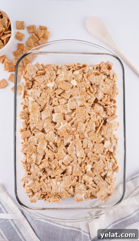 Cinnamon Toast Crunch Marshmallow Bars: Gooey Cereal Treats 7 cinnamon toast crunch treats in pan before slicing