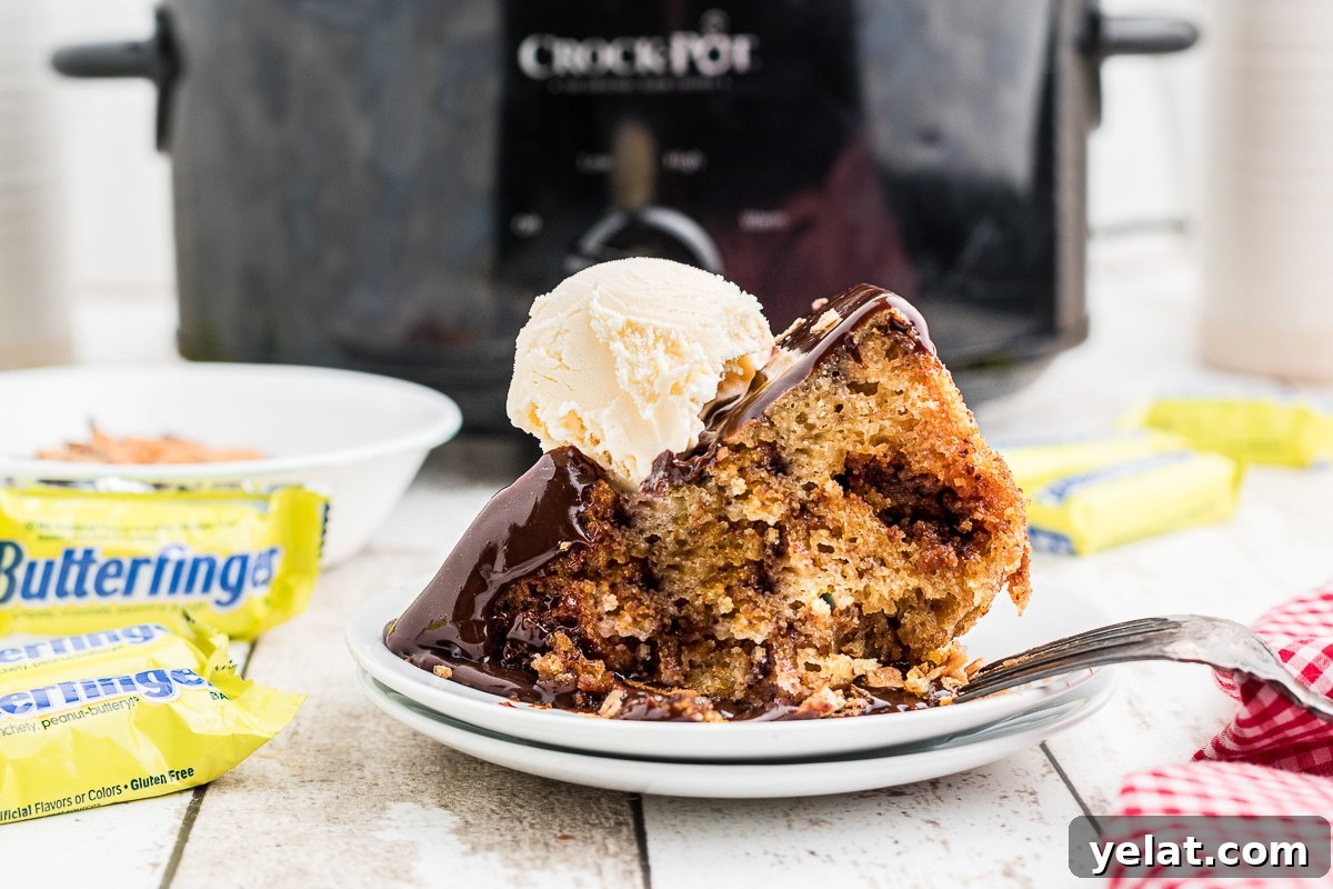 Slow Cooker Butterfinger Dessert Cake Recipe 7 slice of butterfinger cake with ice cream on top.