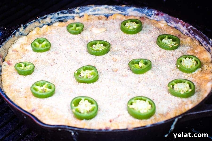Jalapeno Popper Mac and Cheese in cast iron skillet on smoker