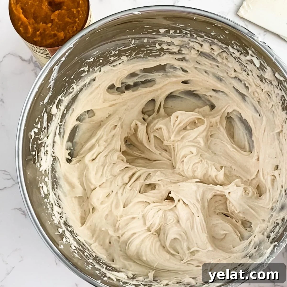 Paula Deen’s Pumpkin Cheesecake Recipe: Southern-Style Dessert Guide 7 beaten cream cheese in a bowl.