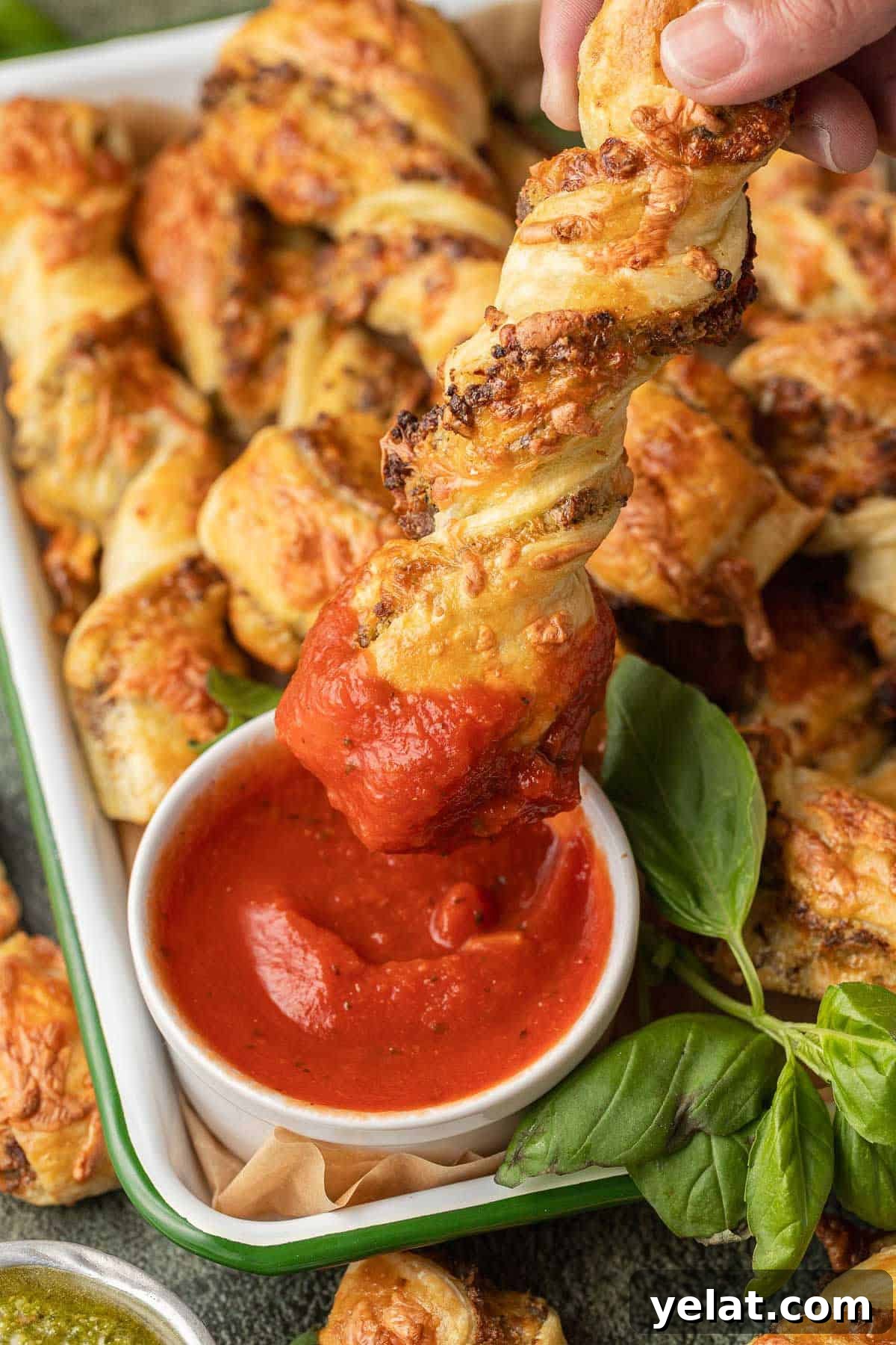 Savory Sausage Puff Pastry Twists Recipe for Parties 3 Sausage Pesto Twists dipping into marinara