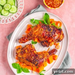Peri-Peri Chicken Recipe: Spicy Portuguese Grilled Chicken Tutorial 11 chicken peri peri on a white plate with vegetables.