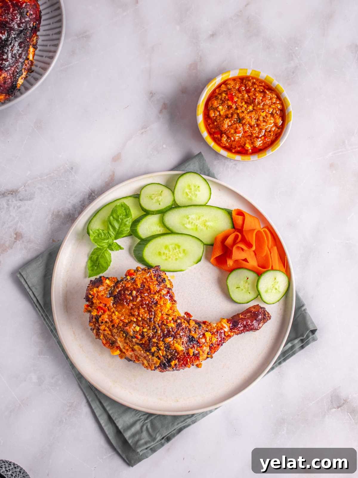 Peri-Peri Chicken Recipe: Spicy Portuguese Grilled Chicken Tutorial 10 peppered chicken with sauce on a white round plate.