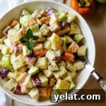 fall fruit salad in white bowl and serving spoon.