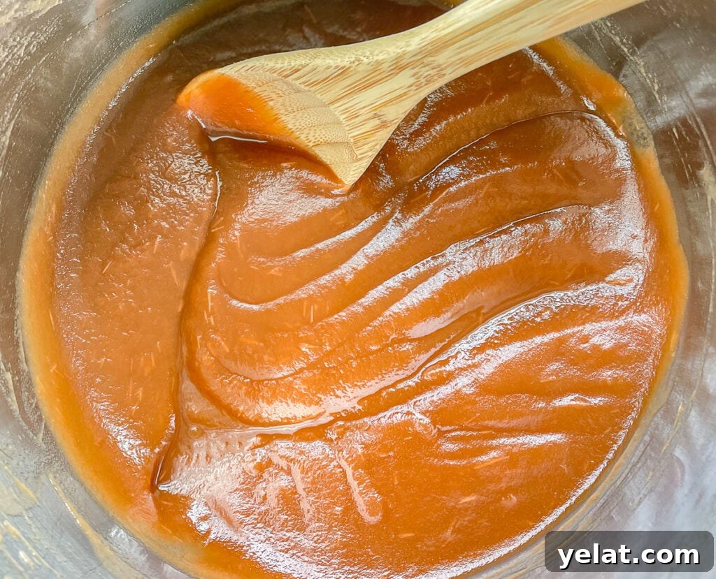 Finishing the apple butter, the spoon should leave drag marks when it's done