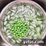 Blanched peas in ice water to cool, scooping out with a small strainer to drain.