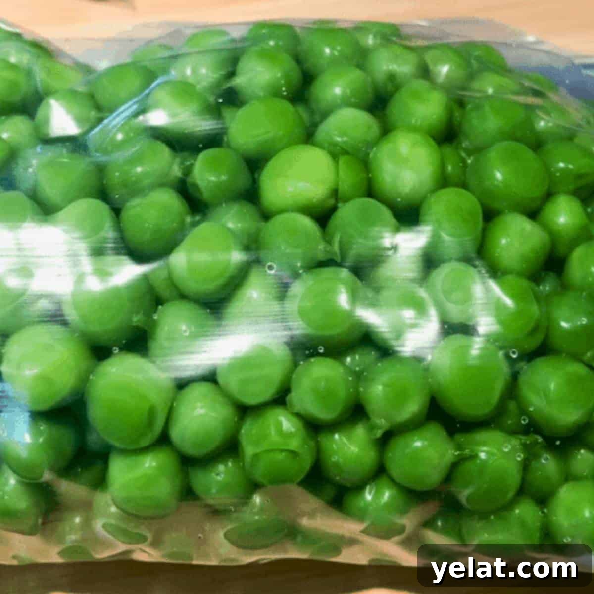 Blanched and drained peas in a freezer bag.