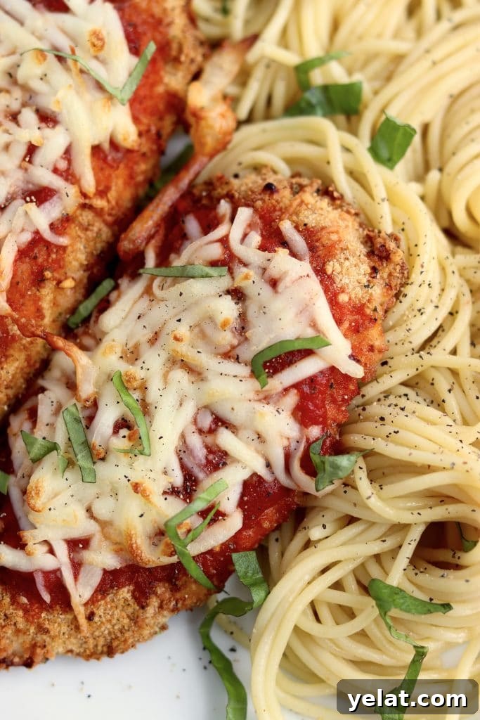 20 Delicious Things to Make in Your Air Fryer Tonight 9 Air fryer chicken parmesan on a plate with spaghetti