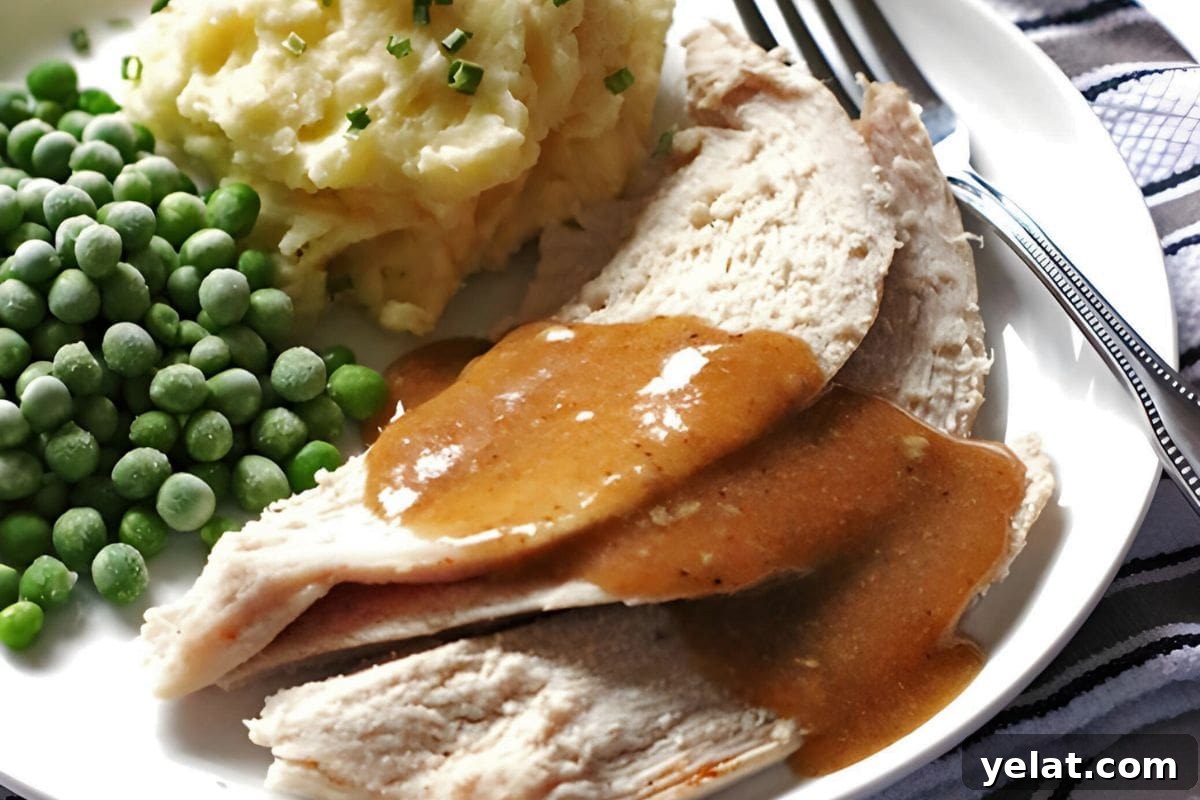 12 Crowd-Pleasing Easter Crockpot Recipes for a Stress-Free Holiday 12 A plate of sliced roast turkey covered in brown gravy, accompanied by mashed potatoes with chives and a serving of green peas.