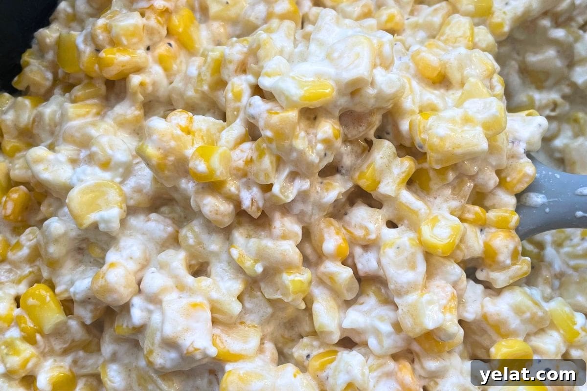 12 Crowd-Pleasing Easter Crockpot Recipes for a Stress-Free Holiday 4 Close-up image of a creamy corn casserole with visible kernels and a spoon.