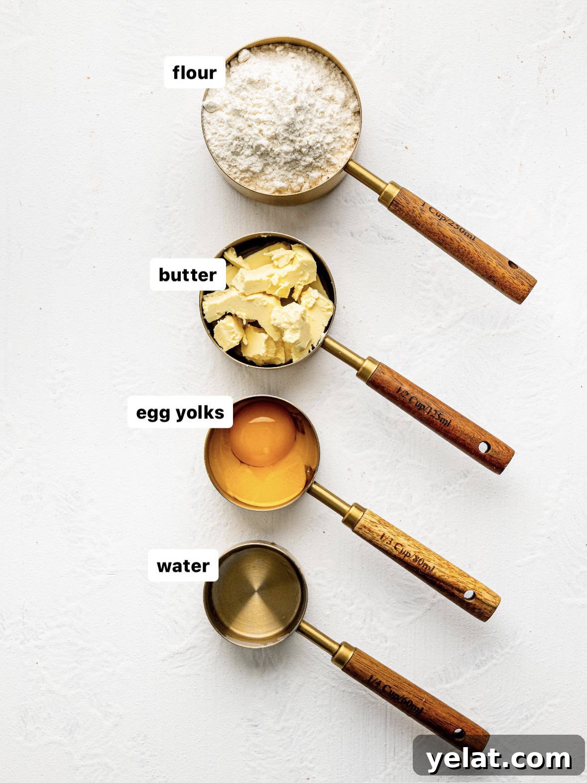 Easy empanada dough ingredients in measuring cups on a counter.