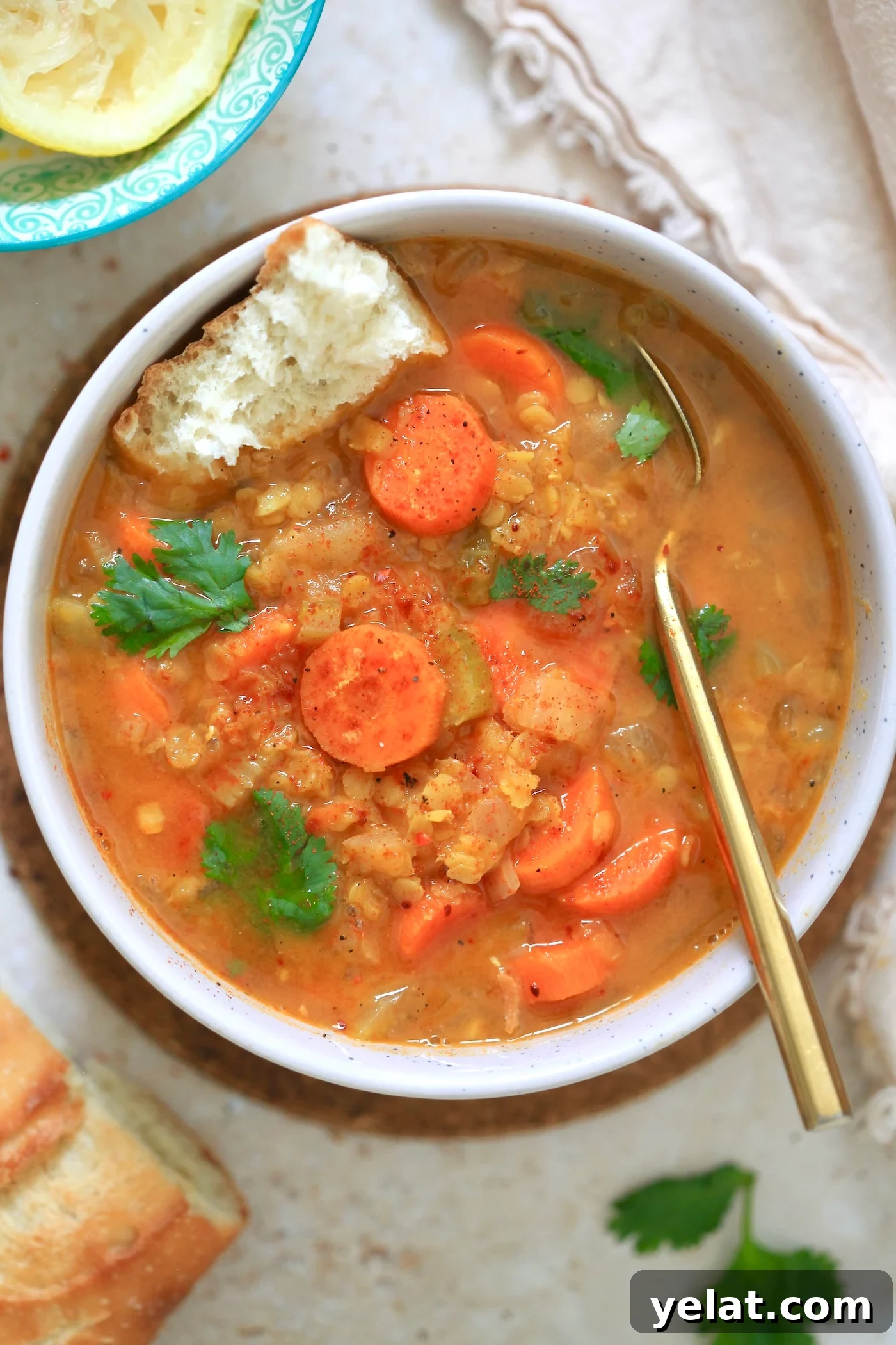 Hearty Carrot and Red Lentil Soup Recipe for Comfort and Flavor 2 orange bowl of soup with carrots and gold spoon