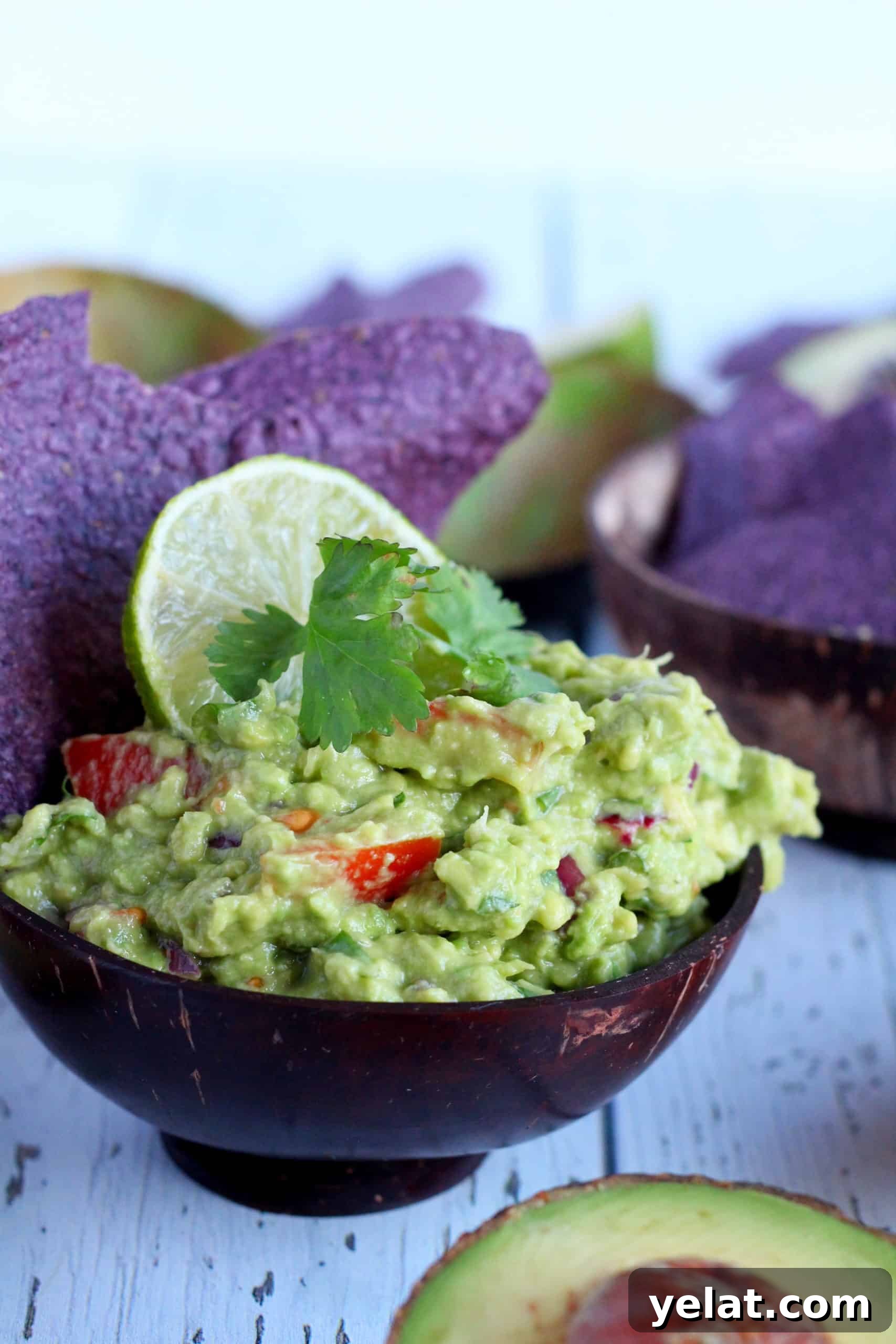 Guacamole Recipe You'll Love: Creamy, Zesty, Guaranteed 2 Guacamole dip in wooden bowl with corn chips