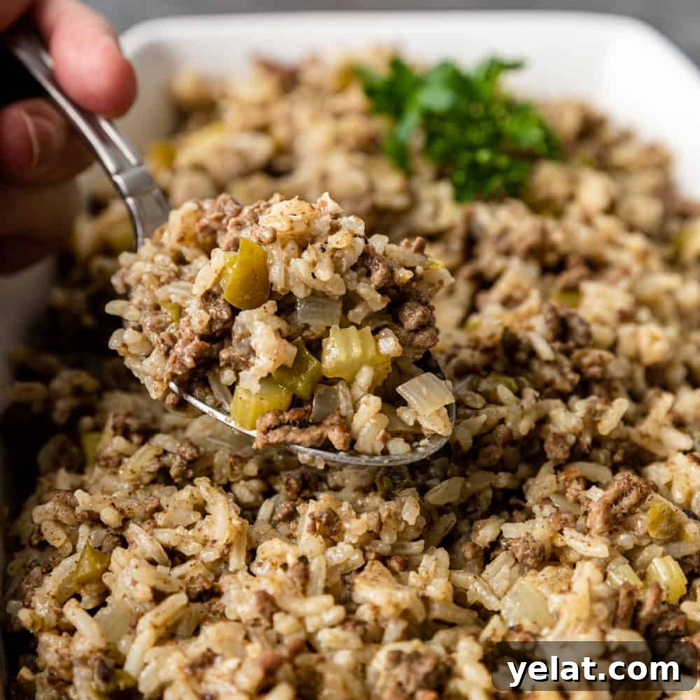 Authentic Cajun Dirty Rice Recipe: Flavorful One-Pot Meal 2 spoonful of Cajun rice side dish above the serving bowl