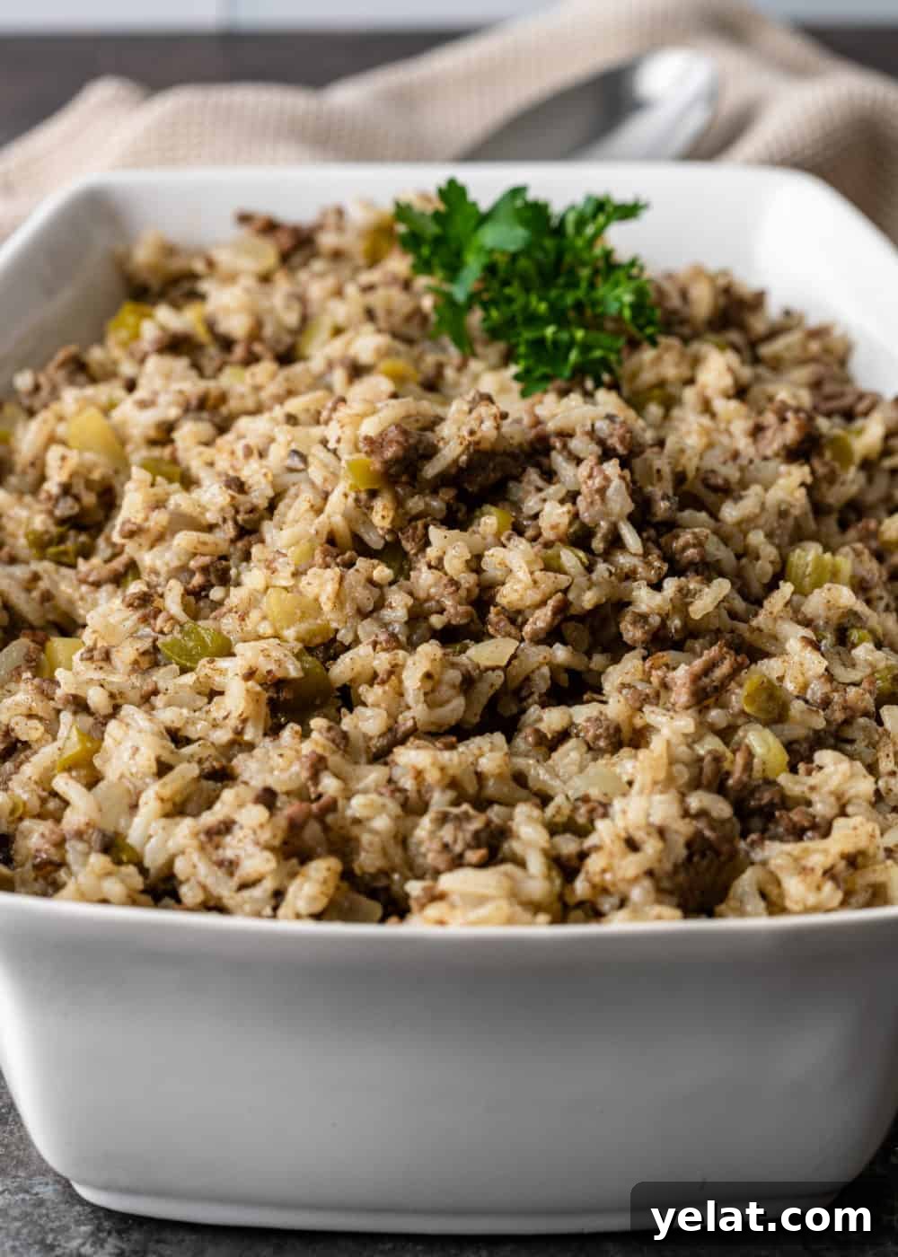 Authentic Cajun Dirty Rice Recipe: Flavorful One-Pot Meal 4 white rectangular casserole dish filled with Cajun dirty rice