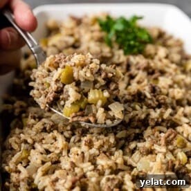 Authentic Cajun Dirty Rice Recipe: Flavorful One-Pot Meal 8 spoonful of a Cajun beef and rice side dish above the serving bowl