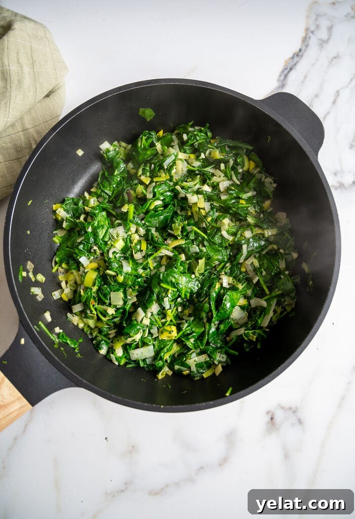 Sautéing the spinach with the leek, shallots and garlic and spinach.