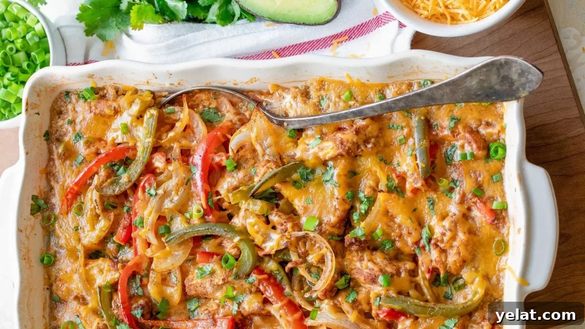 Mexican chicken fajita casserole in a white baking dish.