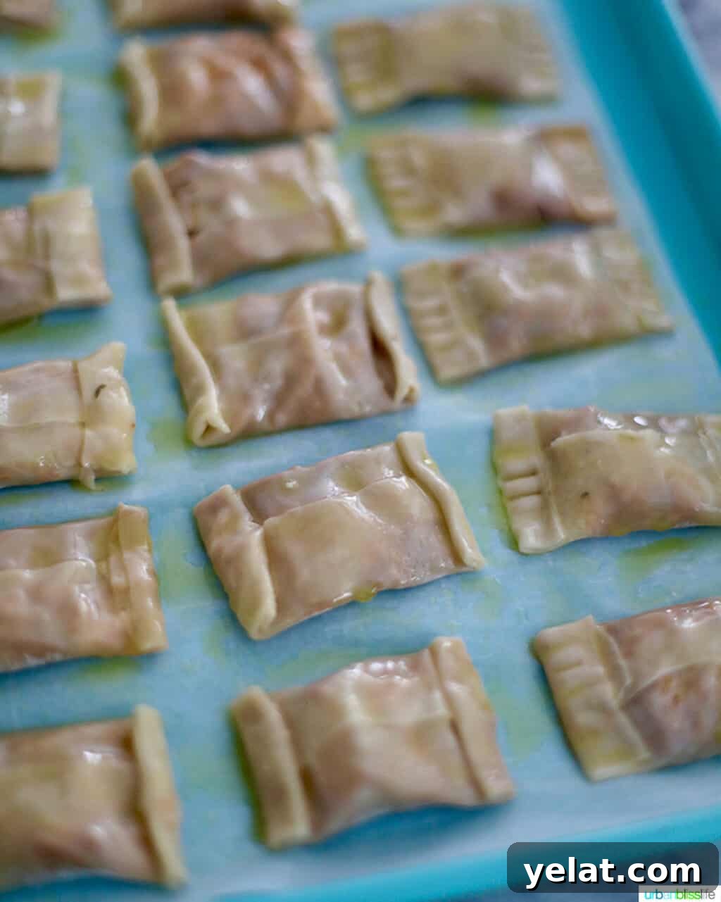 prepped air fryer pizza rolls on blue baking sheet