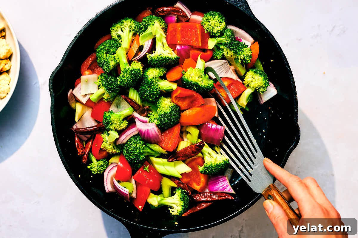 Spicy Kung Pao Tofu with Stir-Fried Vegetables 10 Fresh vegetables being stir fried in a skillet for Kung Pao Vegetables.