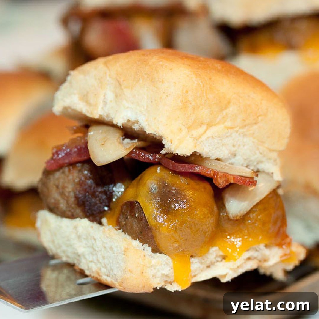 Hawaiian roll with meatballs, melted cheddar cheese, bacon, and sautéed onions