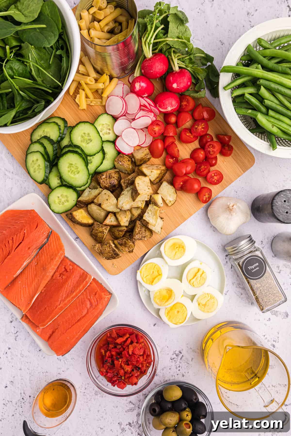 Ingredients for Salmon Nicoise Salad on a gray background.