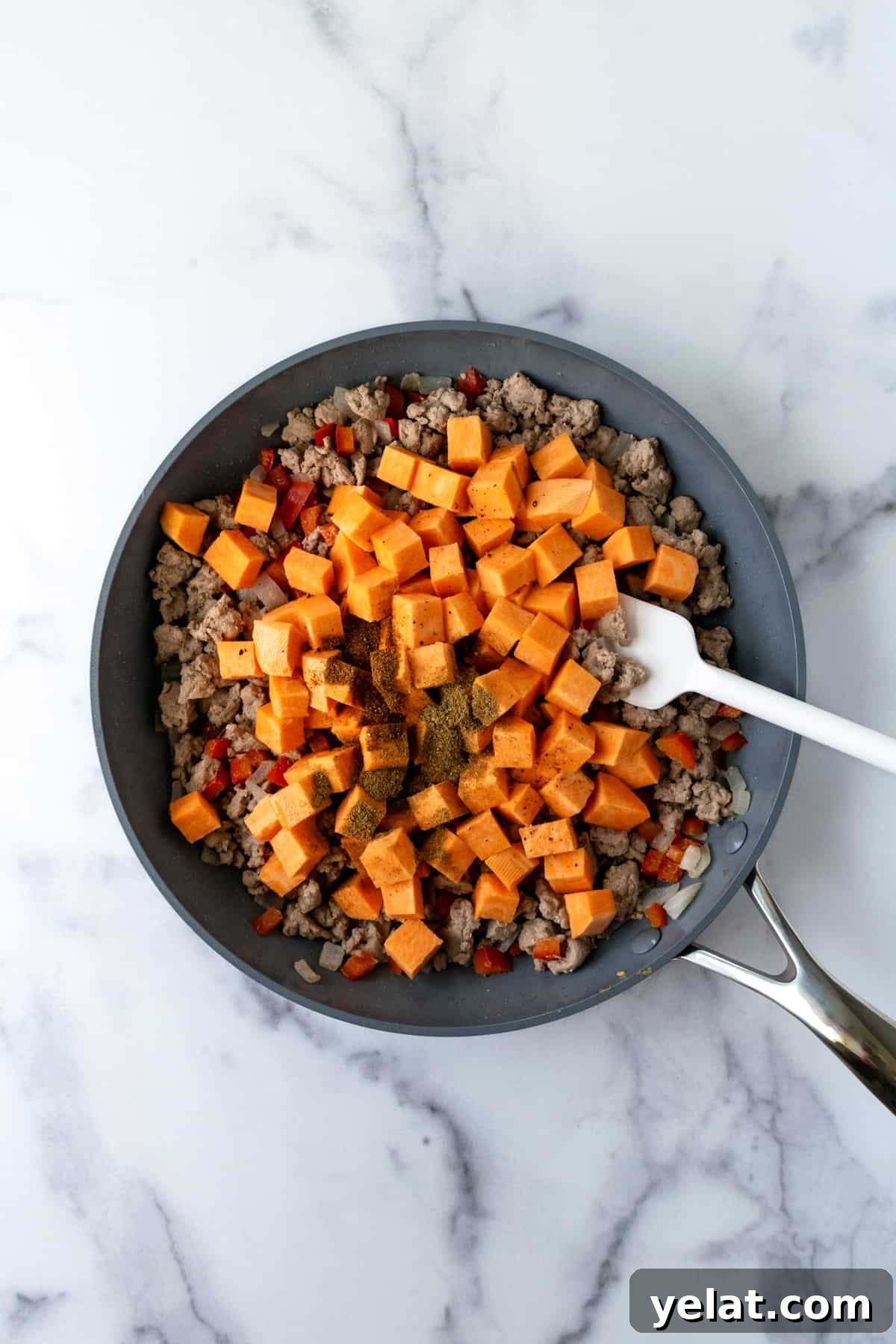 Sweet Potato and Turkey Hash with Spinach & Herbs 5 Sautéing Turkey Hash with Sweet Potatoes in a skillet.