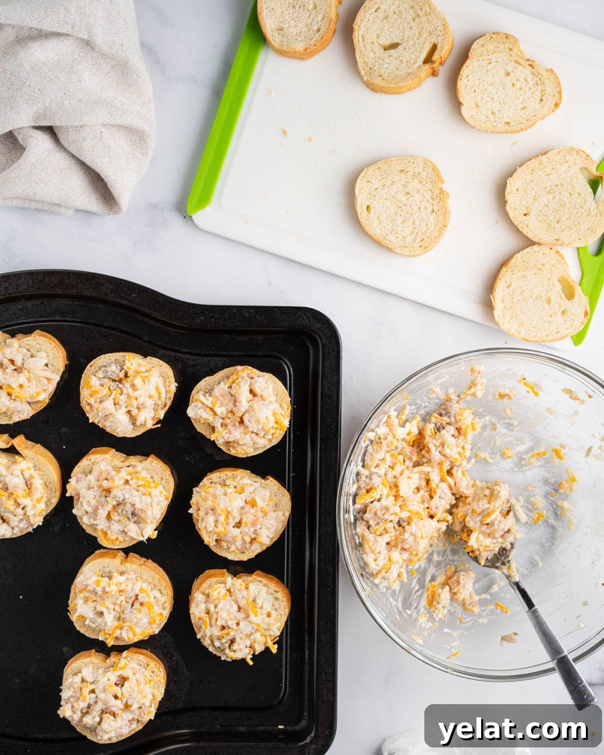 Process of assembling shrimp toast. Cutting board with baguette slices, bowl of shrimp mixture and black baking tray with assembled shrimp toasts.