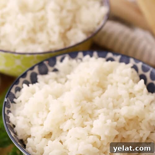 Creamy Coconut Rice with Toasted Coconut Garnish 8 coconut rice in a green bowl, ready to be served
