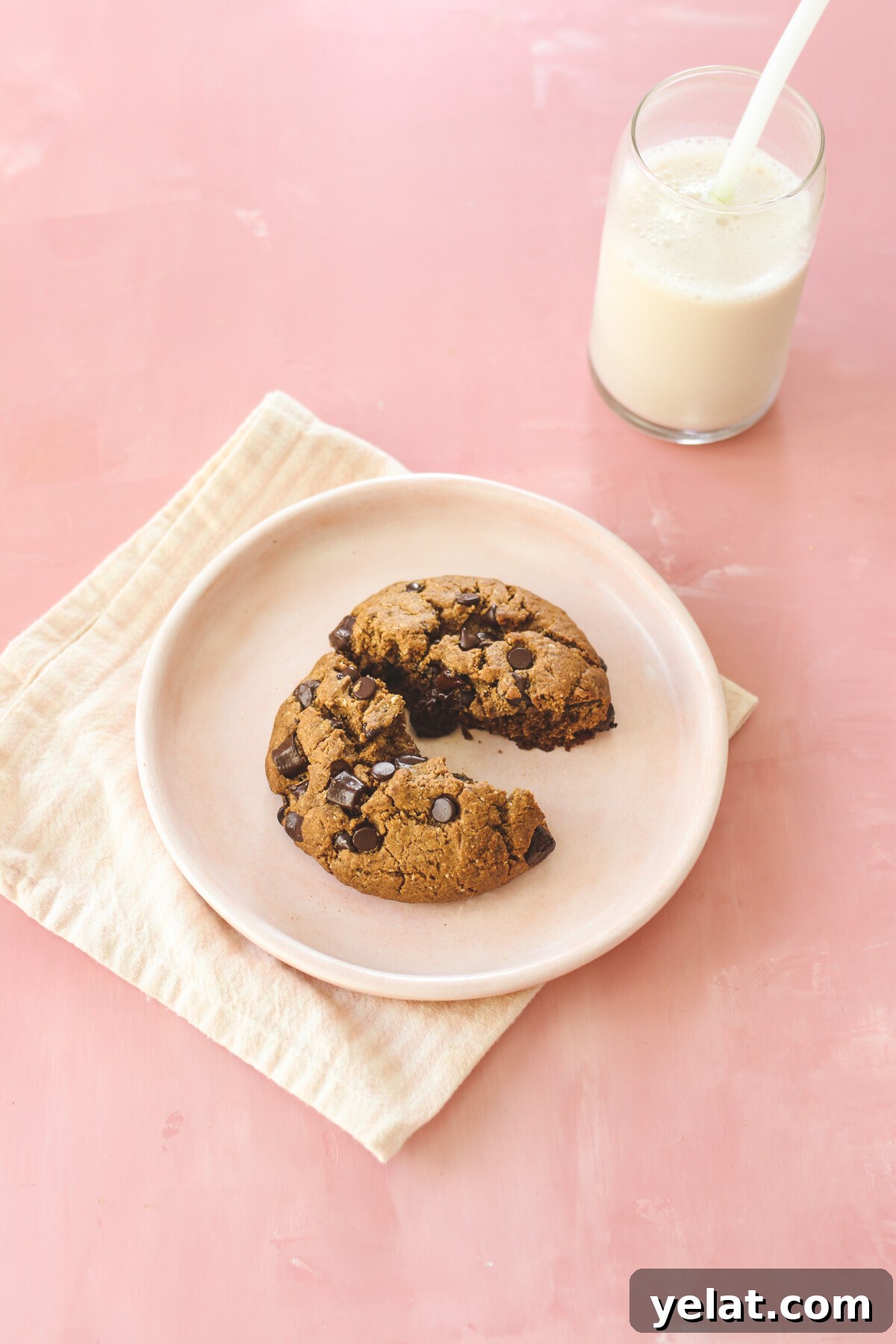 a Levain cookie recipe cookie broken in half to show the soft middle. 