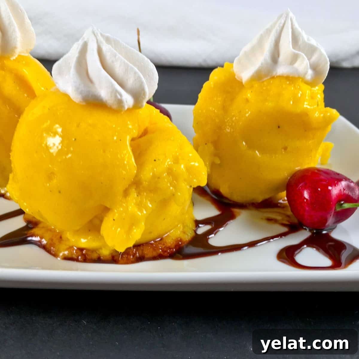 Sugar-Free Mango Frozen Treat: Creamy Dairy-Free Ice Cream Alternative 4 Melting mango nice cream with whipped cream and chocolate sauce