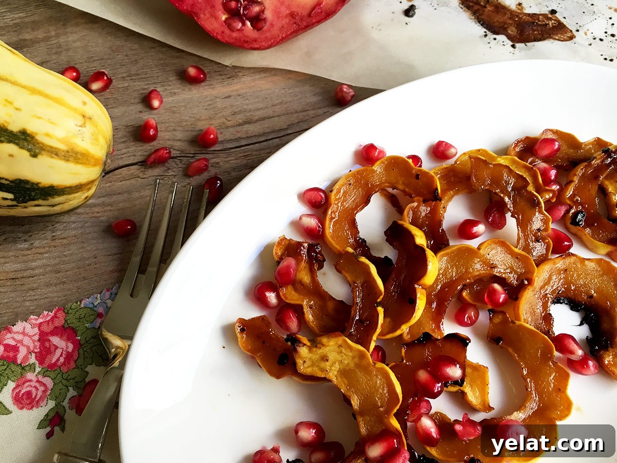 Roasted Delicata Squash with Pomegranate Molasses & Date Syrup 4 Finished squash out of oven on white platter with pomegranate seeds ready for serving.