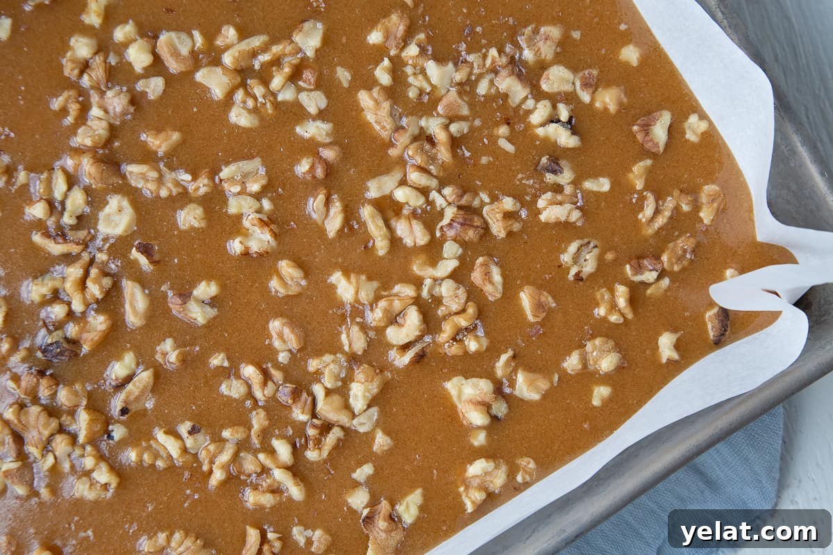 walnut caramels in a metal pan lined with parchment paper.