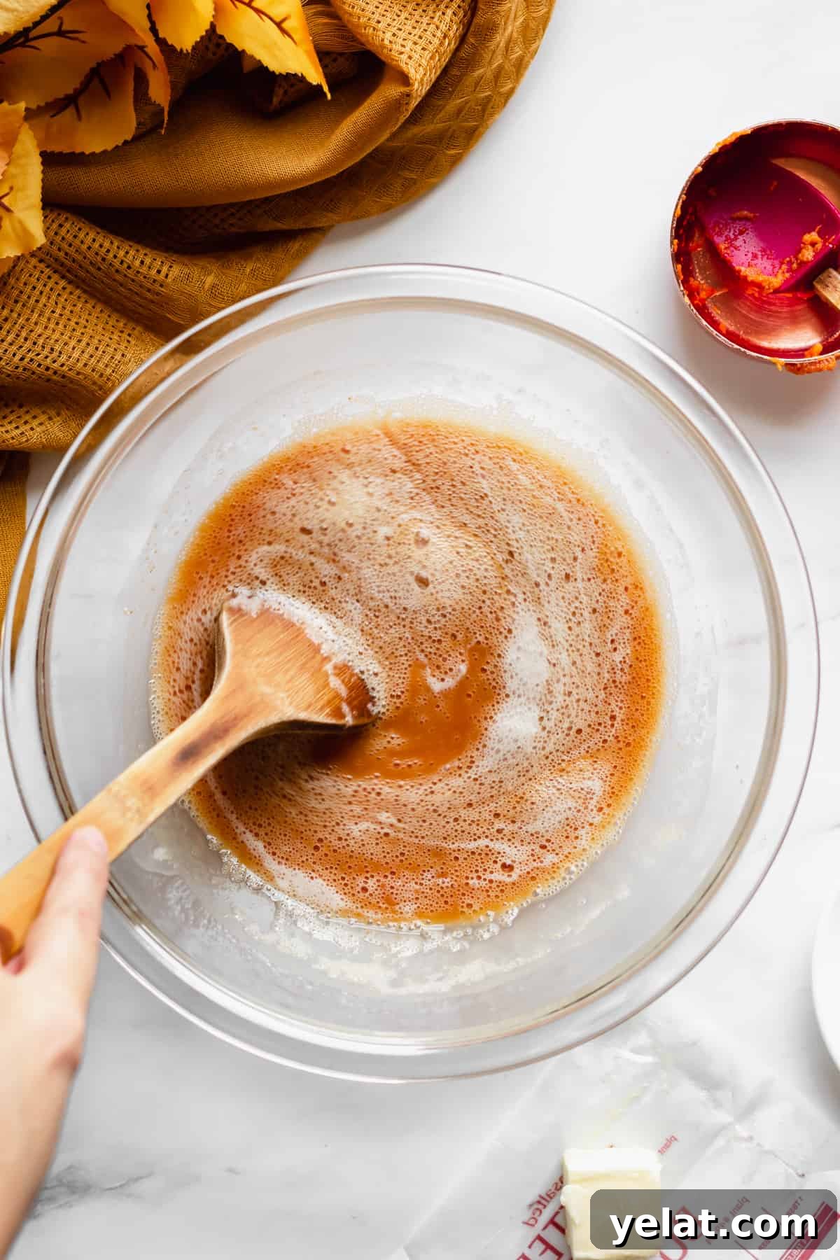 Pumpkin puree being stirred into the water.
