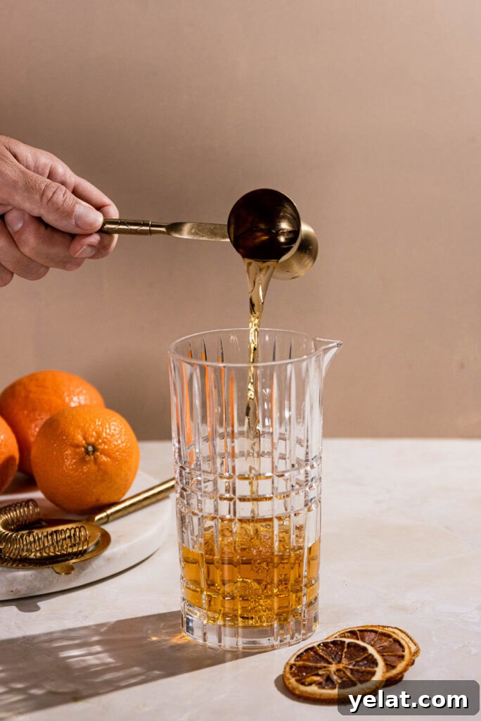 Rum being poured into a cocktail shaker. 
