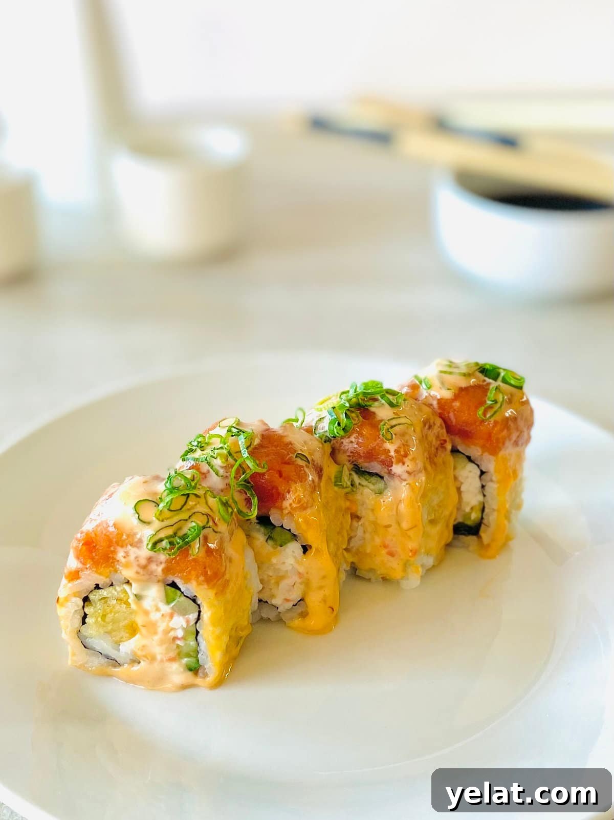 Red Dragon Sushi Roll: Spicy Tuna & Avocado Recipe Guide 6 crazy dragon roll on a plate with soy sauce and chopsticks in the background