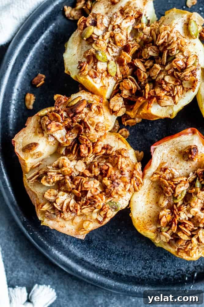 Crispy Air Fryer Apples with Honey Oat Crumble 2 Overhead shot of baked apples on a black plate.