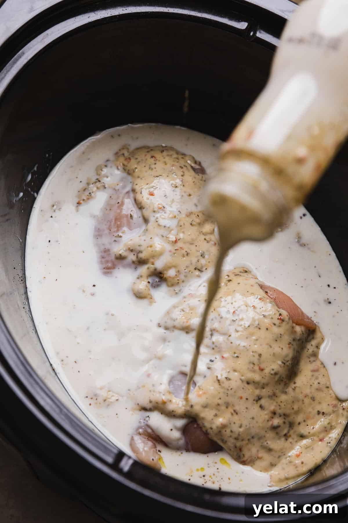 Slow-Cooker Garlic Parmesan Chicken Pasta Recipe 6 milk being poured over uncooked chicken