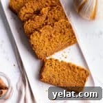 25 Sourdough Breakfast Ideas: 25+ Recipes for Morning Bread Dishes 9 A plate with slices of pumpkin bread.