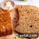 25 Sourdough Breakfast Ideas: 25+ Recipes for Morning Bread Dishes 11 Slices of sourdough zucchini bread on a cutting board with a dish of butter.