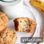 25 Sourdough Breakfast Ideas: 25+ Recipes for Morning Bread Dishes 12 A plate with banana muffins and a glass of milk with a banana.