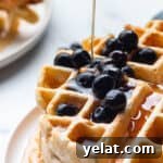 25 Sourdough Breakfast Ideas: 25+ Recipes for Morning Bread Dishes 4 A stack of sourdough waffles with blueberries and syrup.
